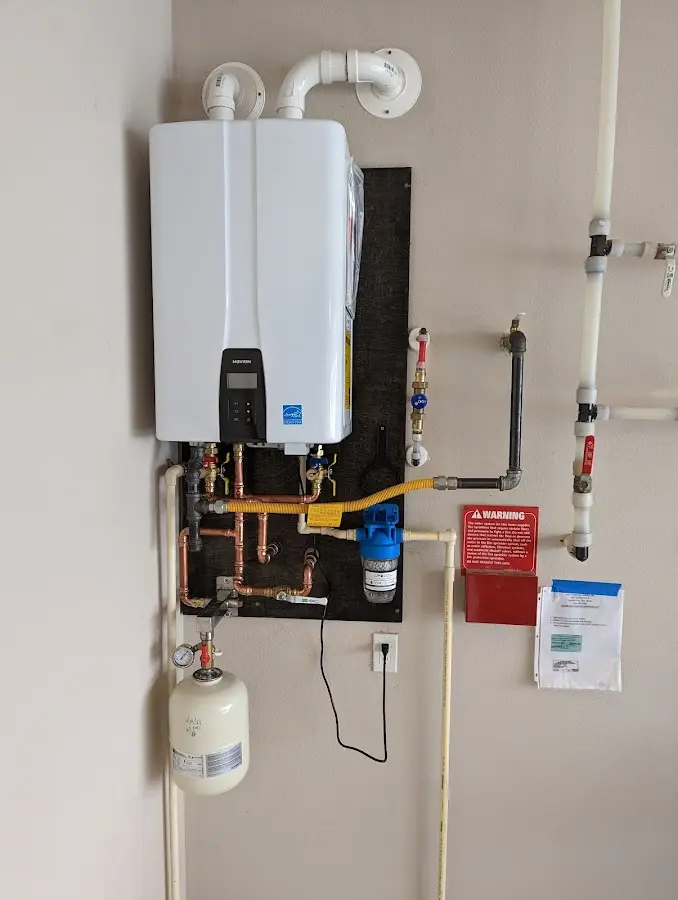 Professional plumber installing copper piping in a Western Springs home